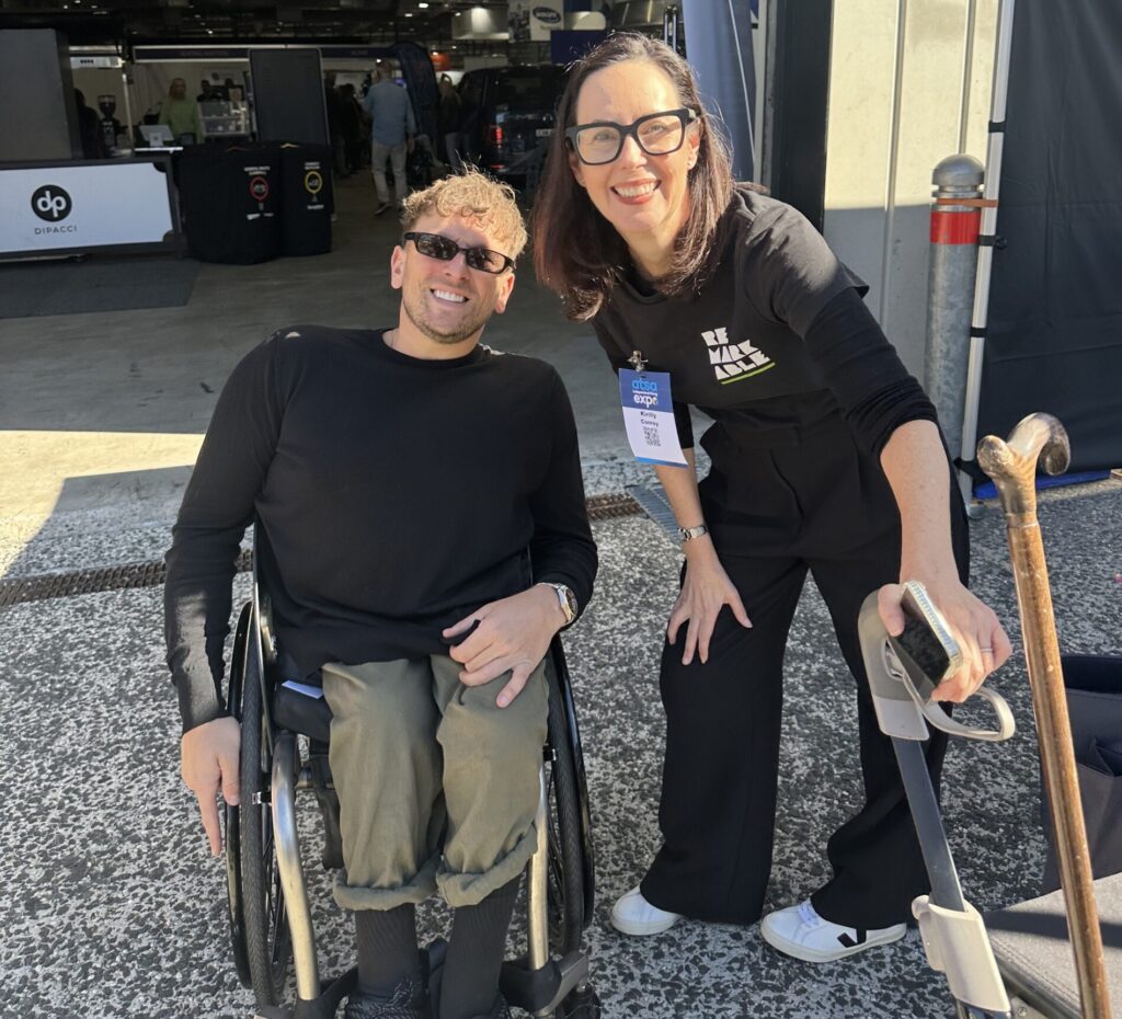 A photo of Kirilly and Dylan at an event, smiling at the camera.